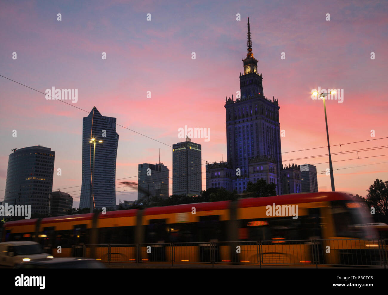 The Palace of Science & Culture and other skyscrapers against a backdrop of a pink sunset sky in Warsaw, Poland. Stock Photo