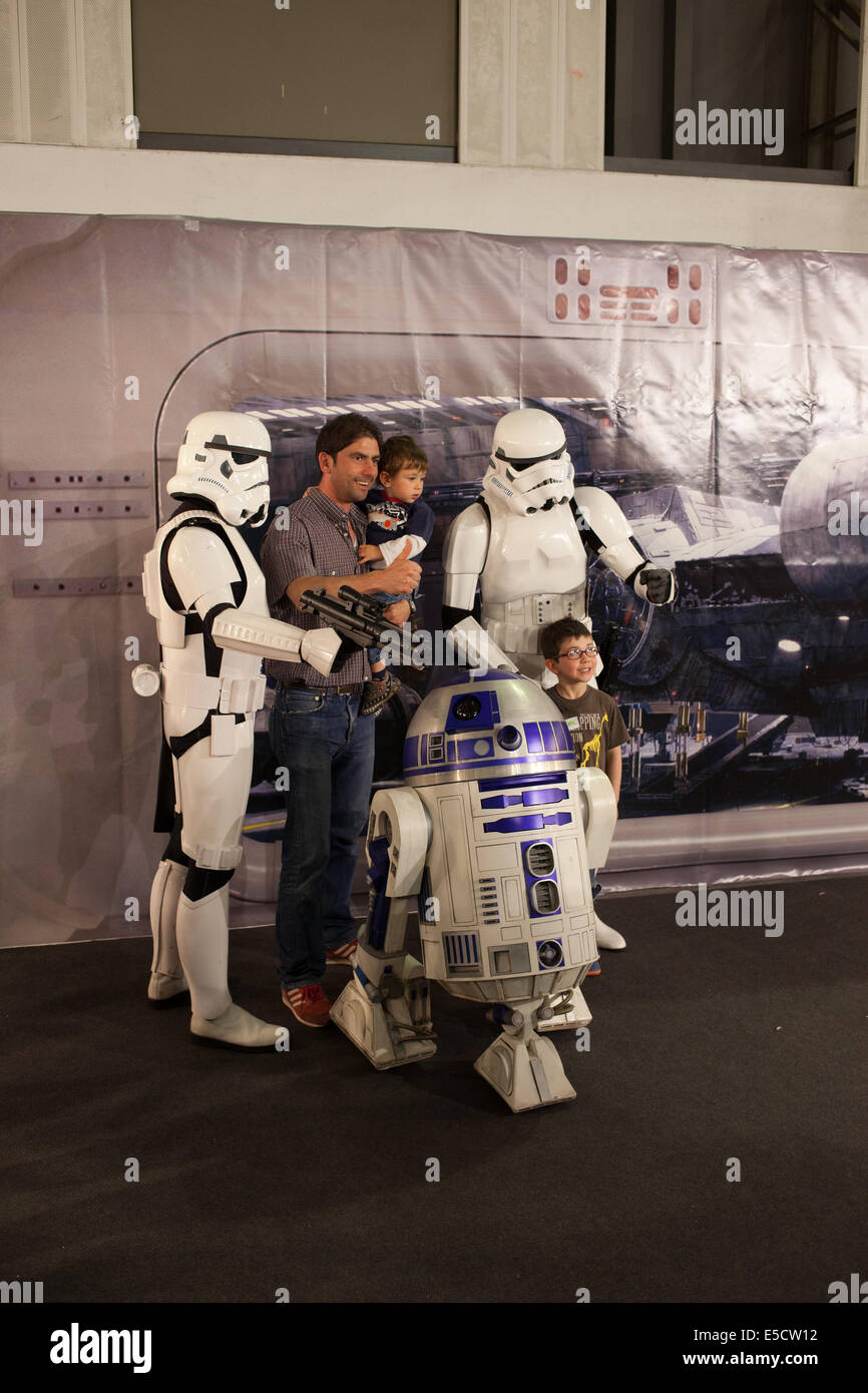 Man and two boys with R2-D2 and Stormtroopers from Star Wars at Barcelona International Comic Fair on May 17, 2014 in Barcelona, Catalonia, Spain. Stock Photo