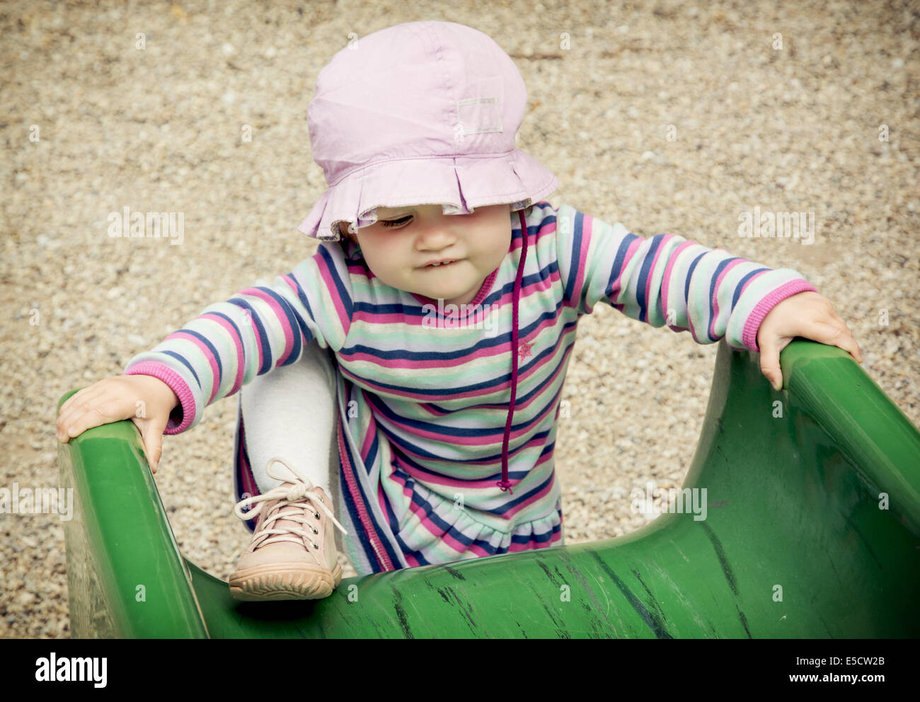 Little caucasian girl and playground slide Stock Photo - Alamy