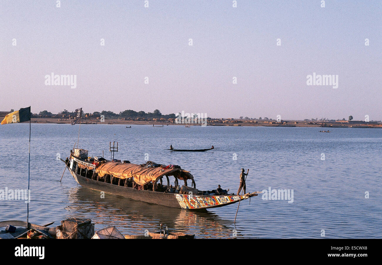 African man pinnace navigating the river Niger in Mopti, most important commercial port of Mali Stock Photo