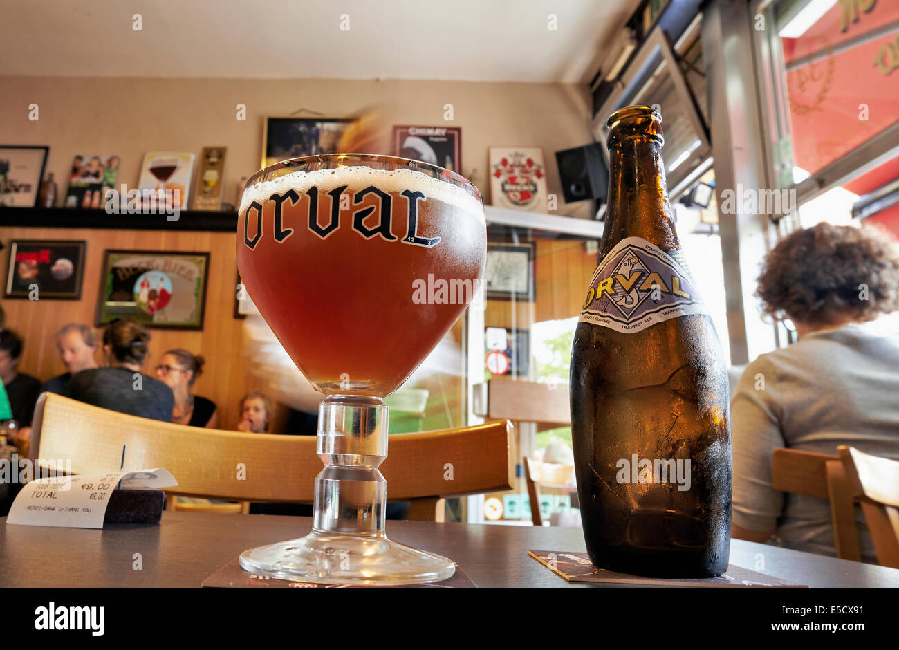 Orval Trappist Belgian Ale bottle and glass on a table opposite in a