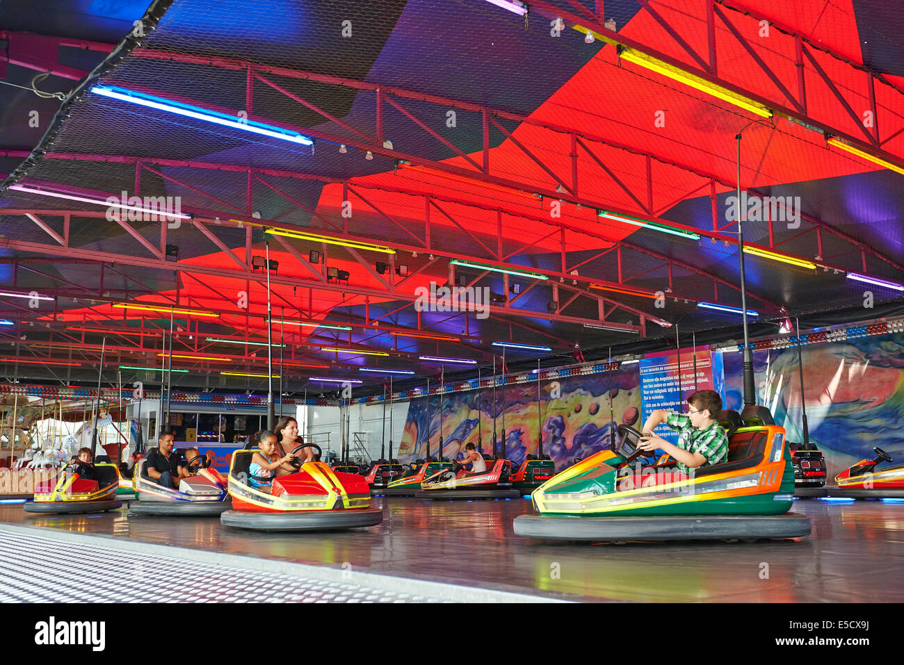 Some people having fun to drive a bumper car in the amusement park