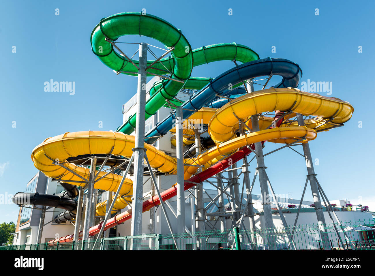 Tube slides at water park against blue sky Stock Photo