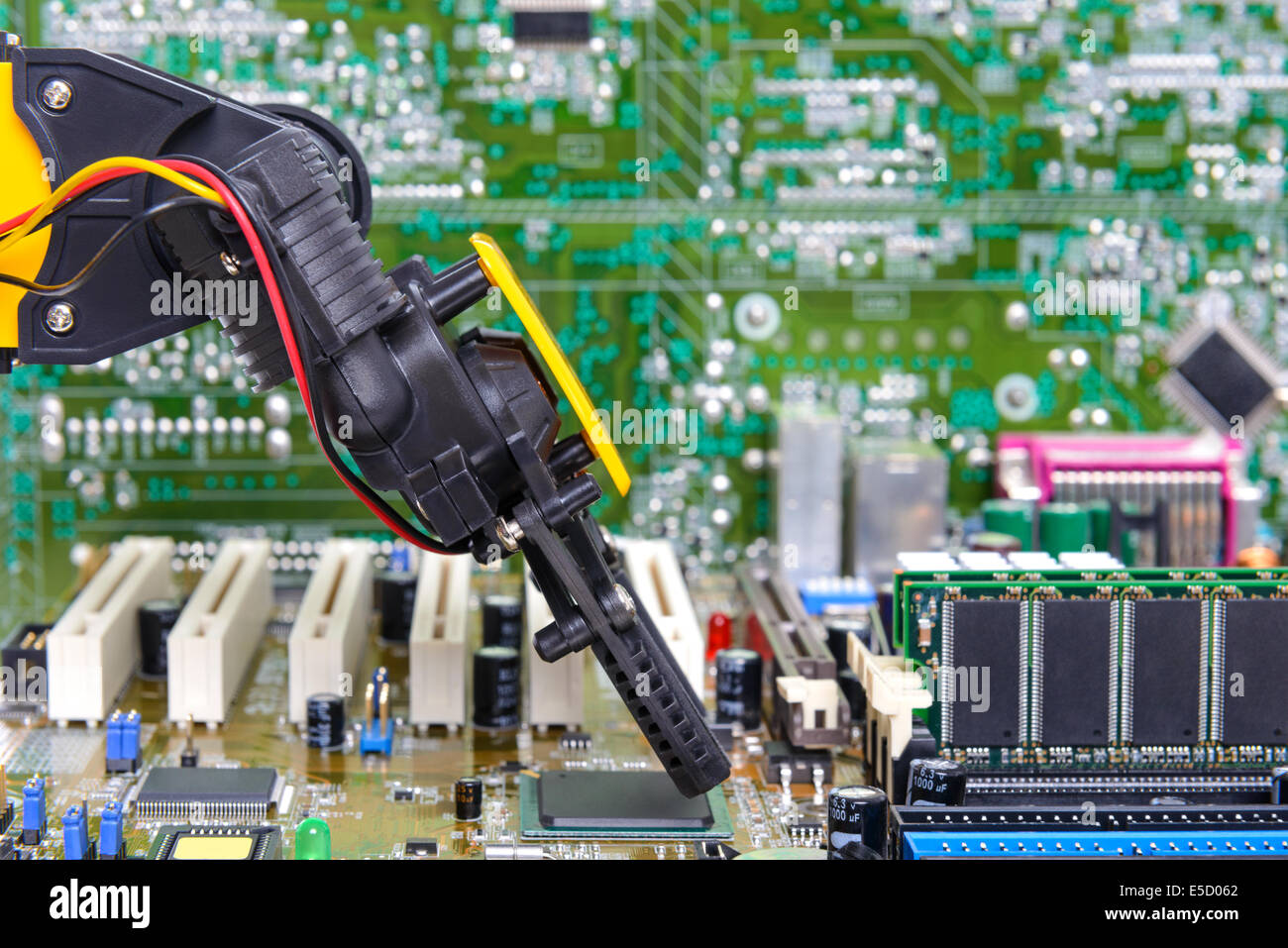 Robotic arm installing a computer chip Stock Photo
