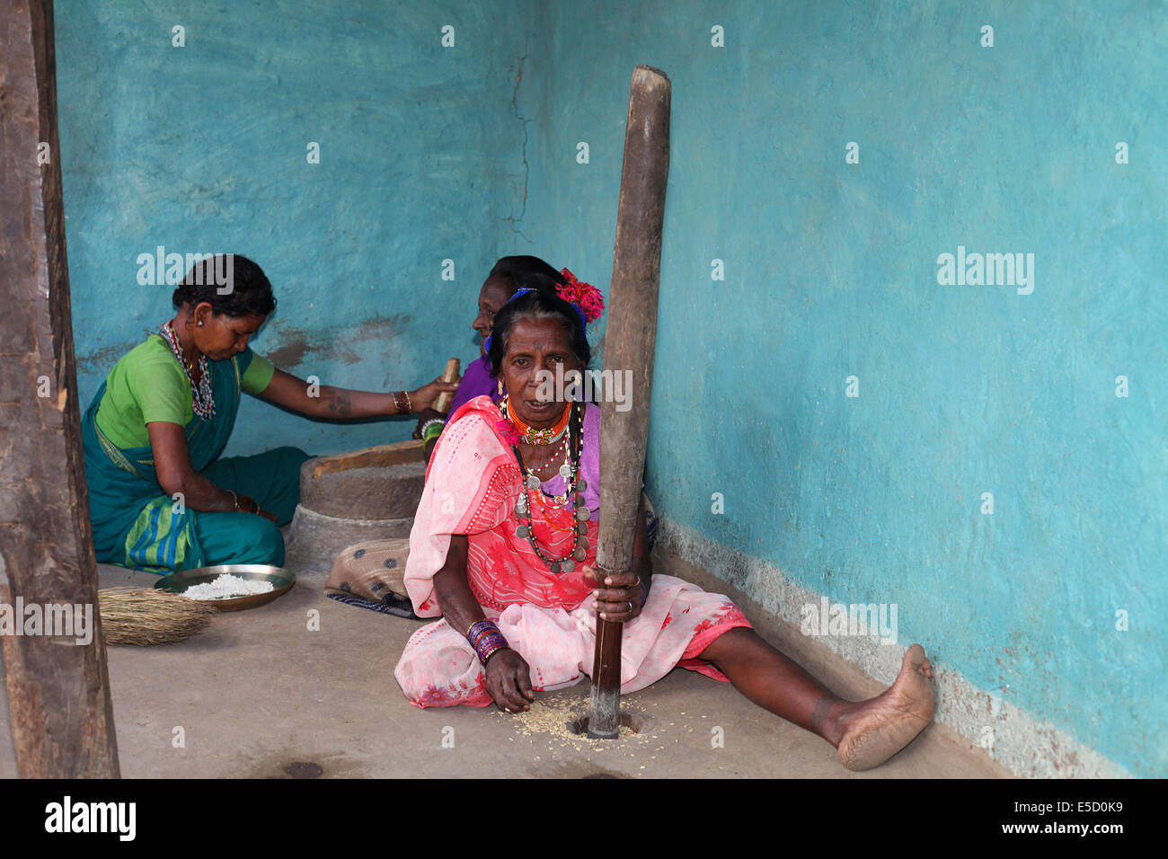 Tribal women pounding rice, Baiga tribe. Karangra Village, Chattisgadh, India Stock Photo
