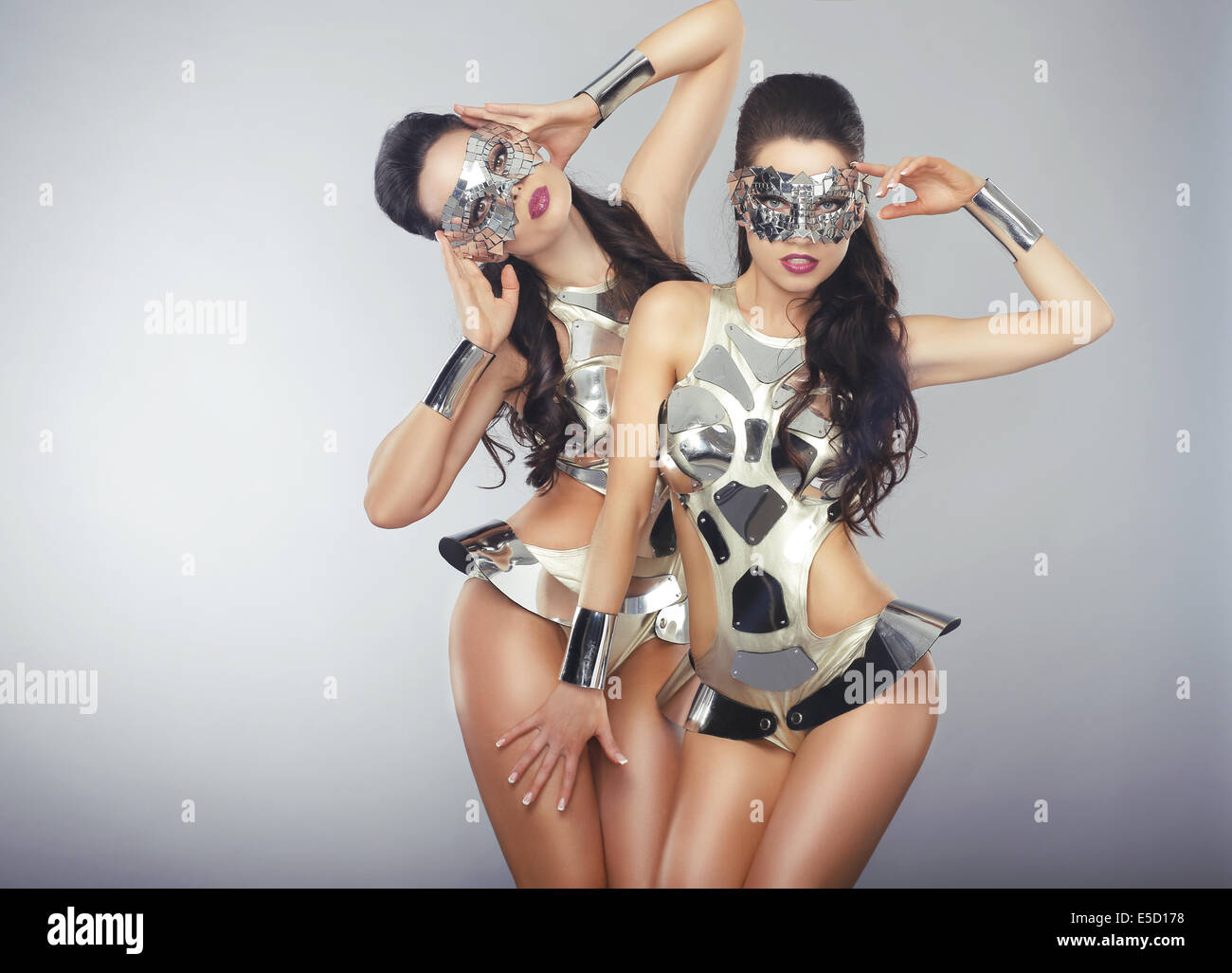 Vogue. People in Sparkling Cosmic Cyber Costumes Gesturing Stock Photo