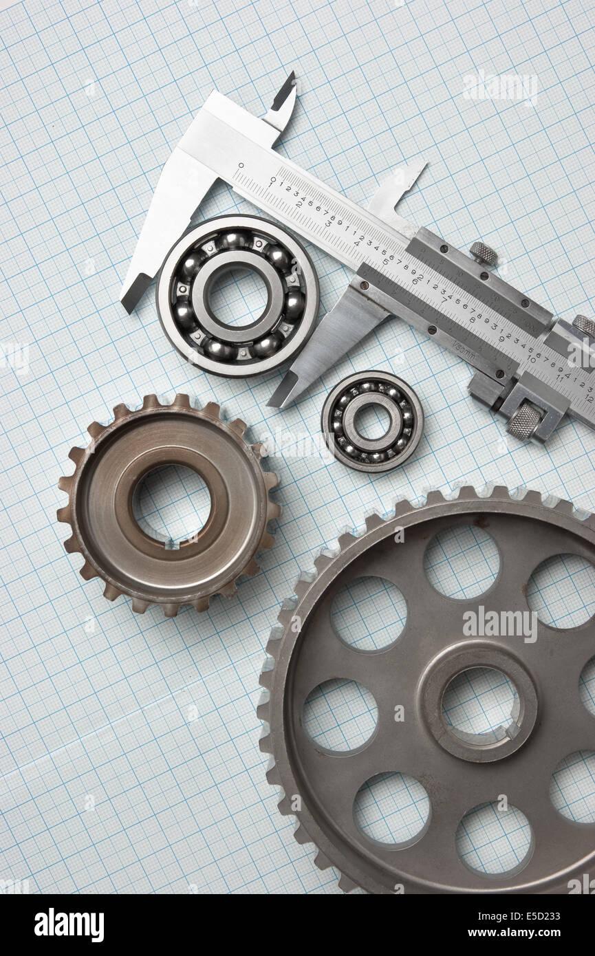 caliper with gears and bearings on graph paper Stock Photo Alamy