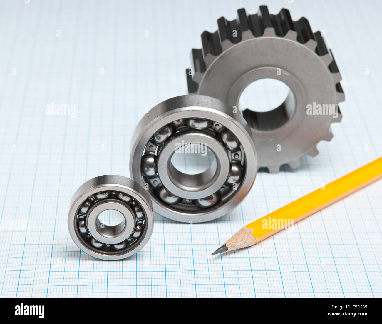 gears and bearings on graph paper Stock Photo Alamy