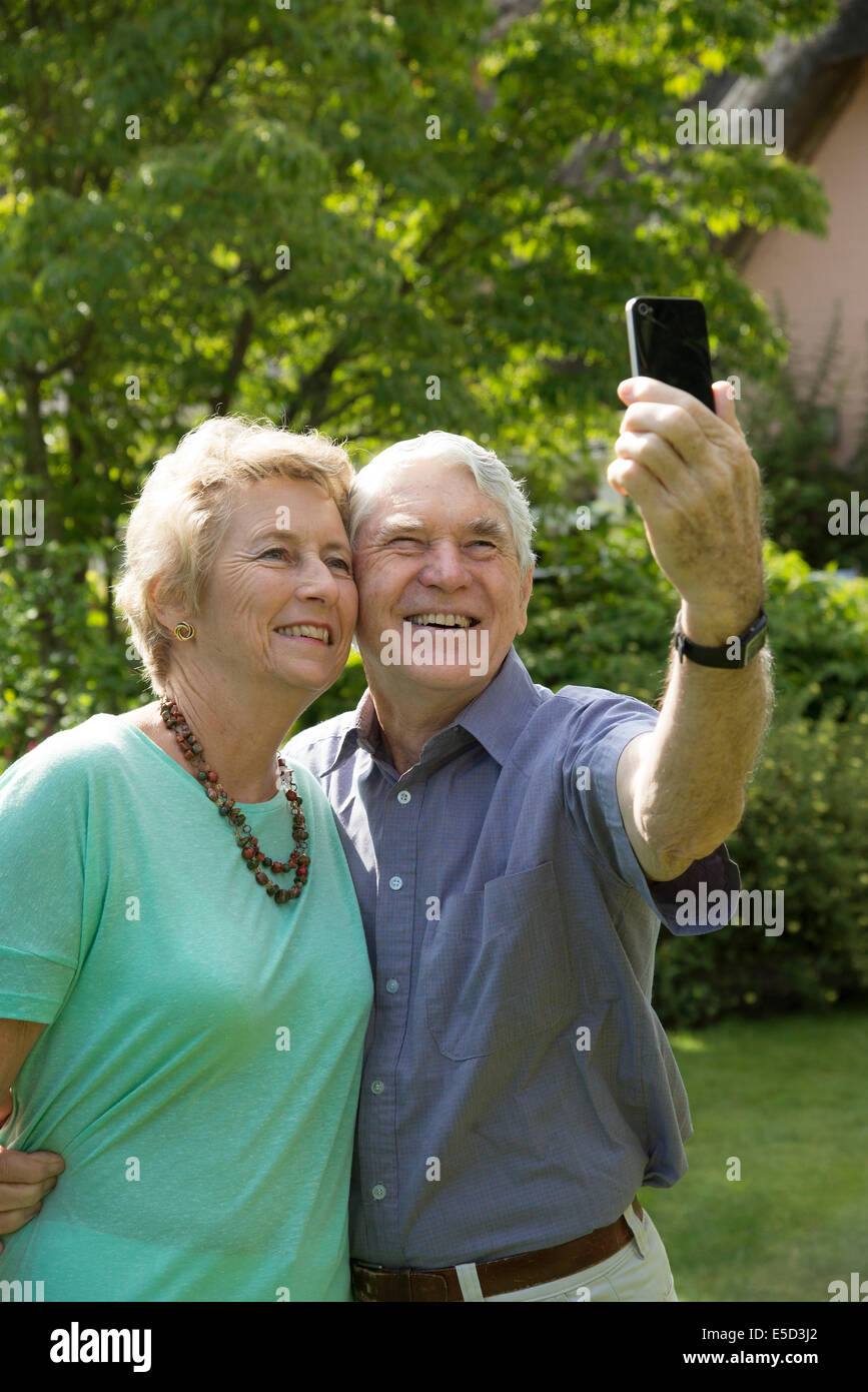 Elderly couple taking a selfie photo with a mobile phone Stock Photo ...