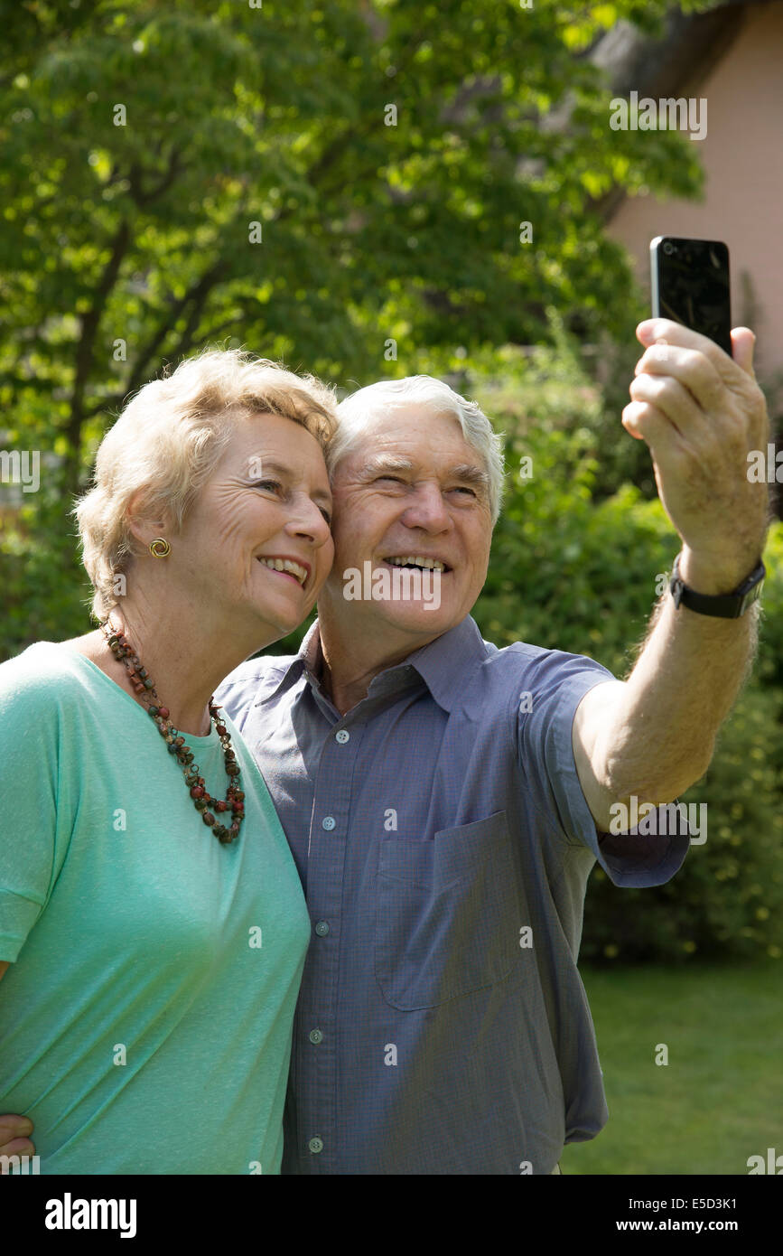 Elderly couple taking a selfie photo with a mobile phone Stock Photo ...