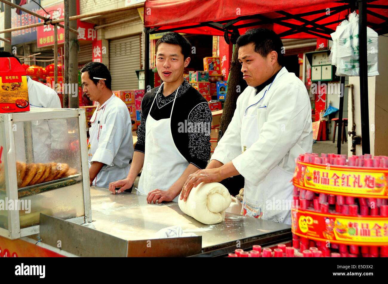 JUN LE TOWN, CHINA:  Chefs at work kneading dough and preparing the famous Jun Le Town Chinese Pizzas Stock Photo