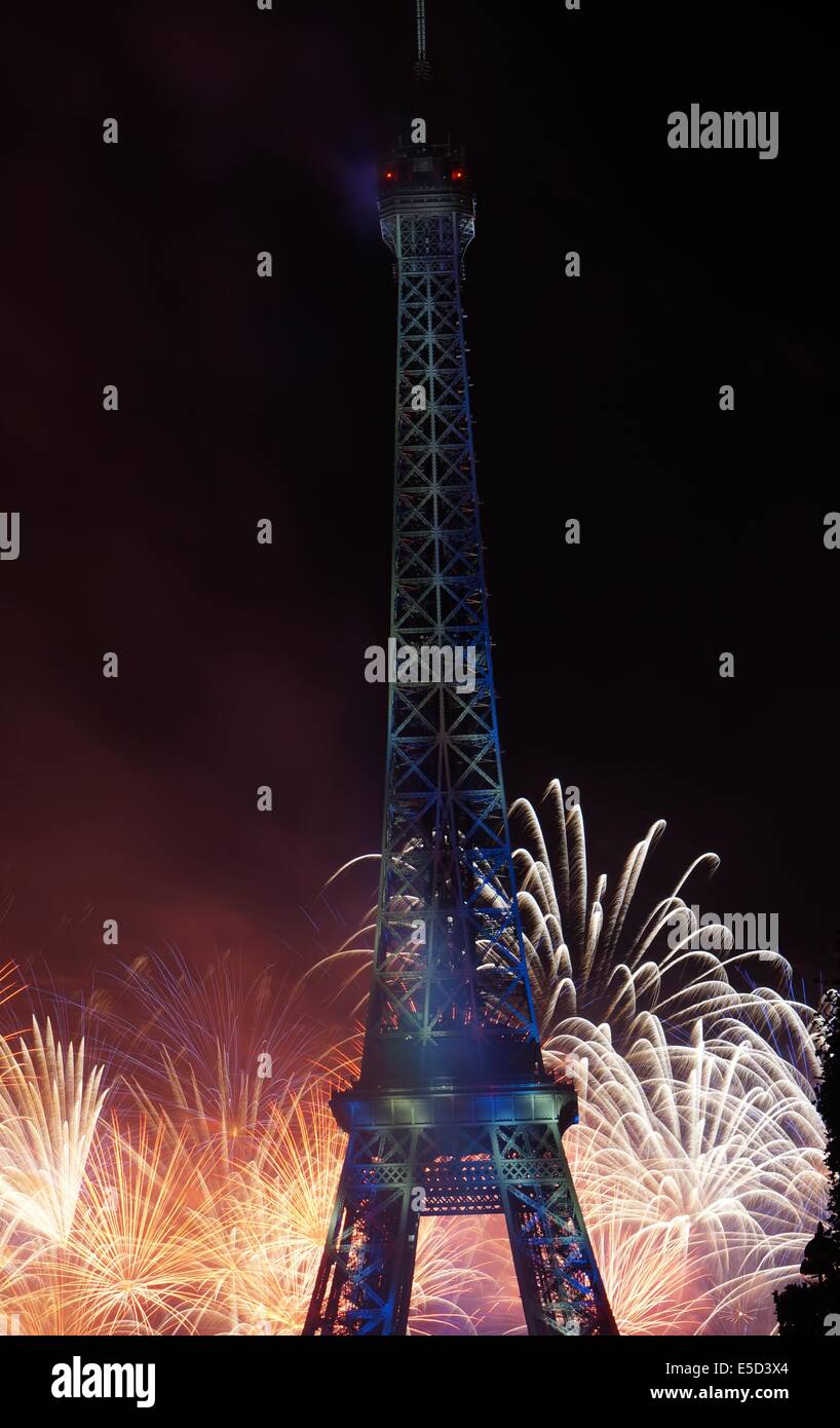 Fireworks at the bottom of the Eiffel Tower in blue by night on Bastille Day French National Holiday Stock Photo