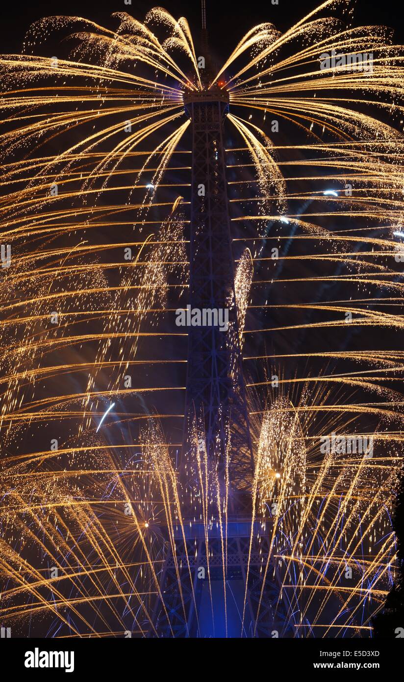 Eiffel Tower by night in blue lit up by fountain like fireworks on Bastille Day French National Holiday Stock Photo