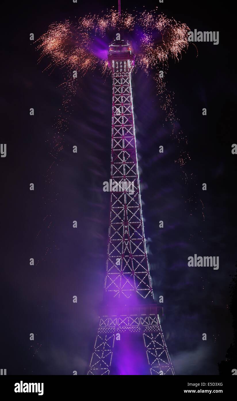 The Purple themed night Eiffel Tower with white lights on, special cap like fireworks on top on Bastille Day Stock Photo