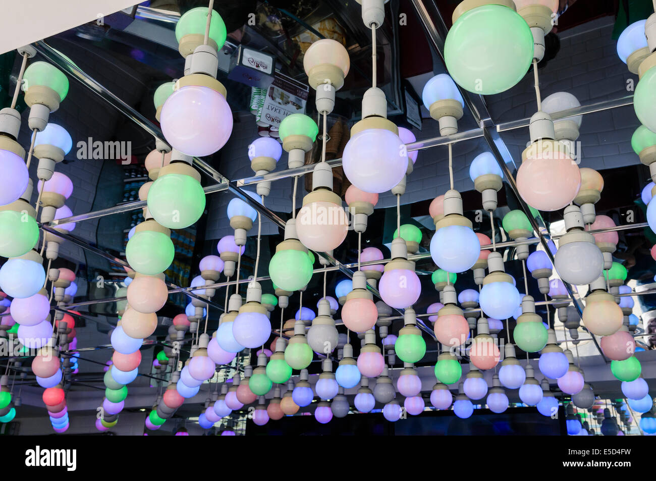 Multicoloured LED bulbs on a mirrored ceiling Stock Photo