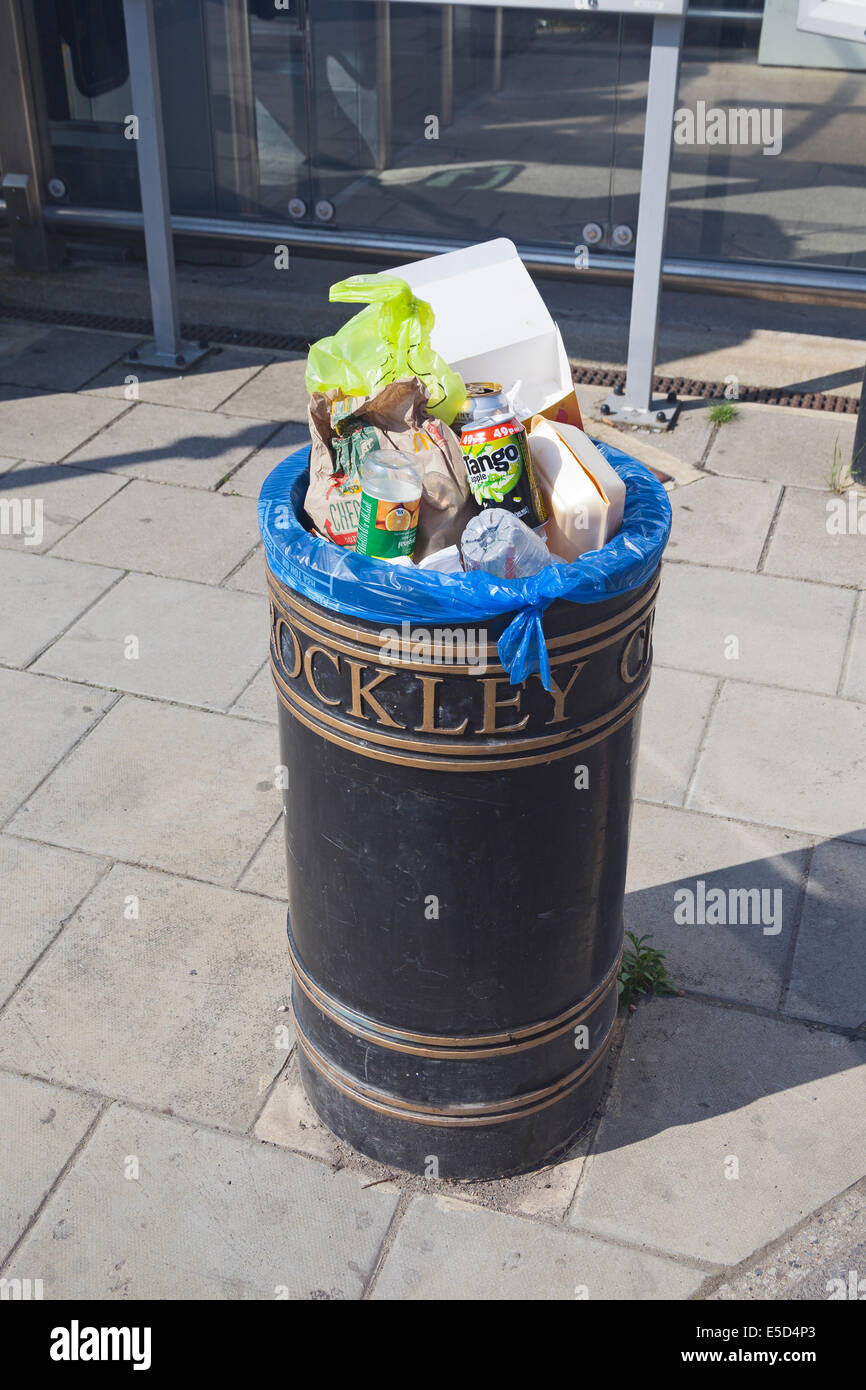 London, Lewisham. An overflowing litter bin at Brockley station Stock Photo