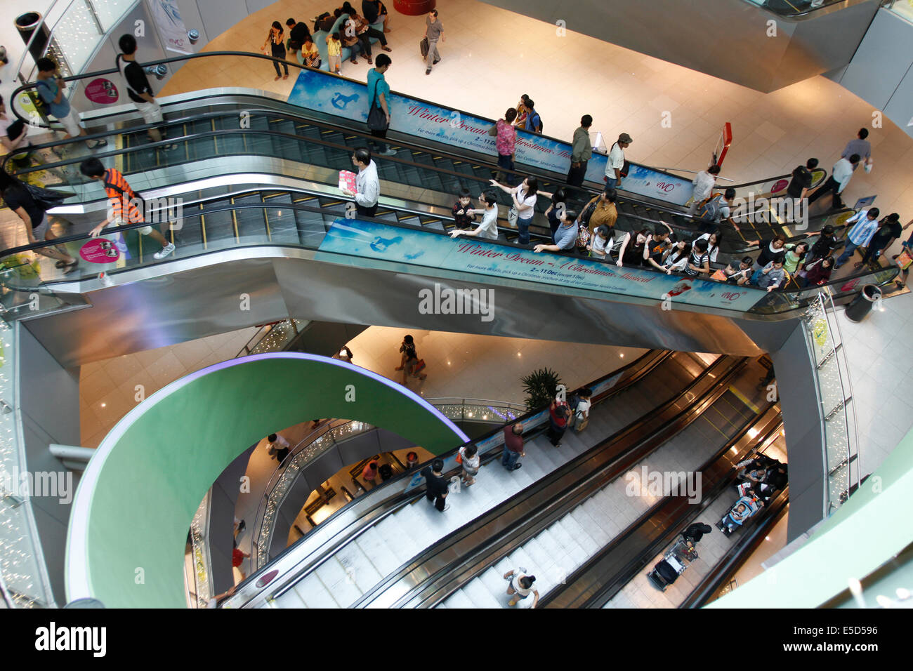 Shoppers on escalators in department store in Singapore Stock Photo - Alamy