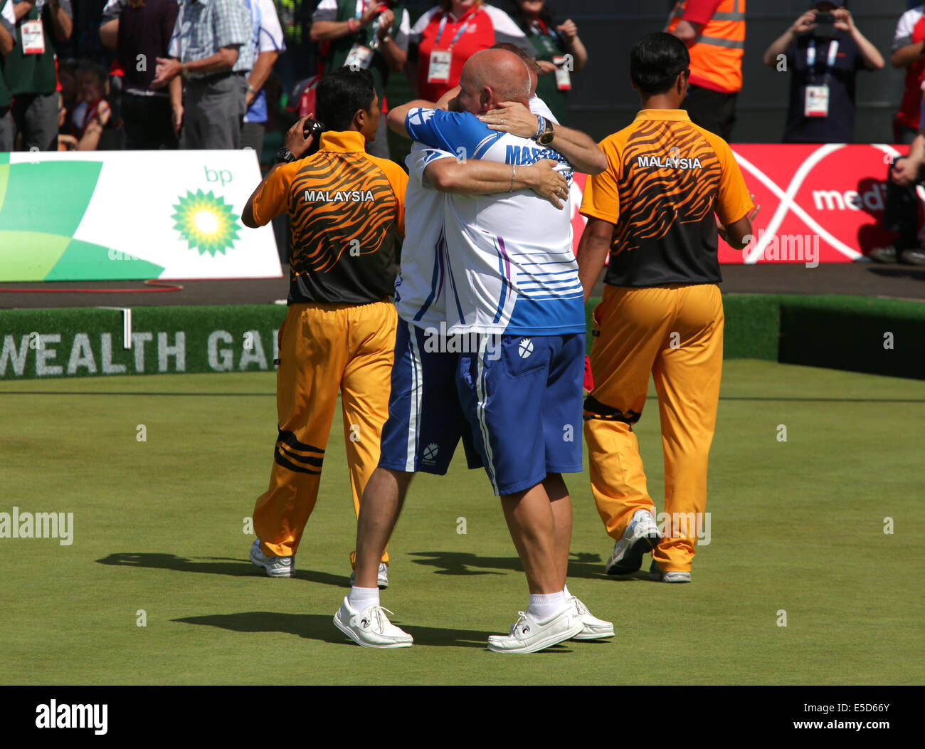 Kelvingrove Lawn Bowls Centre, Glasgow, Scotland, UK, Monday, 28th July, 2014. Scotland's Paul Foster and Alex Marshall celebrate winning Gold in the Men's Lawn Bowls Pairs Final defeating Malaysia's Muhammad Hizlee Abdul Rais and Fairul Izwan Abd Muin at the Glasgow 2014 Commonwealth Games Stock Photo