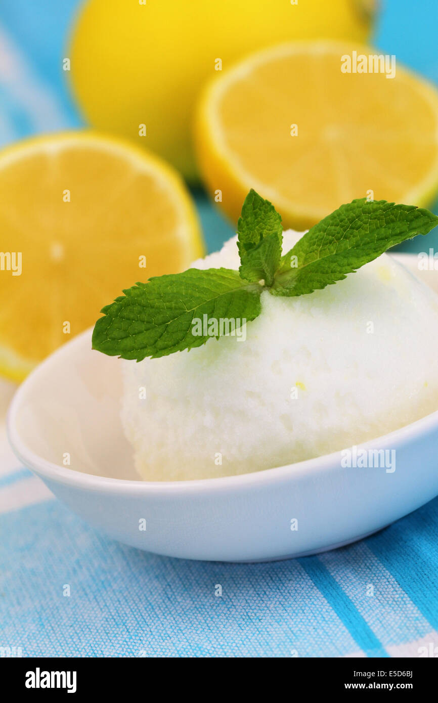 Scoop of refreshing lemon sorbet icecream with zest and mint on a white  background Stock Photo - Alamy