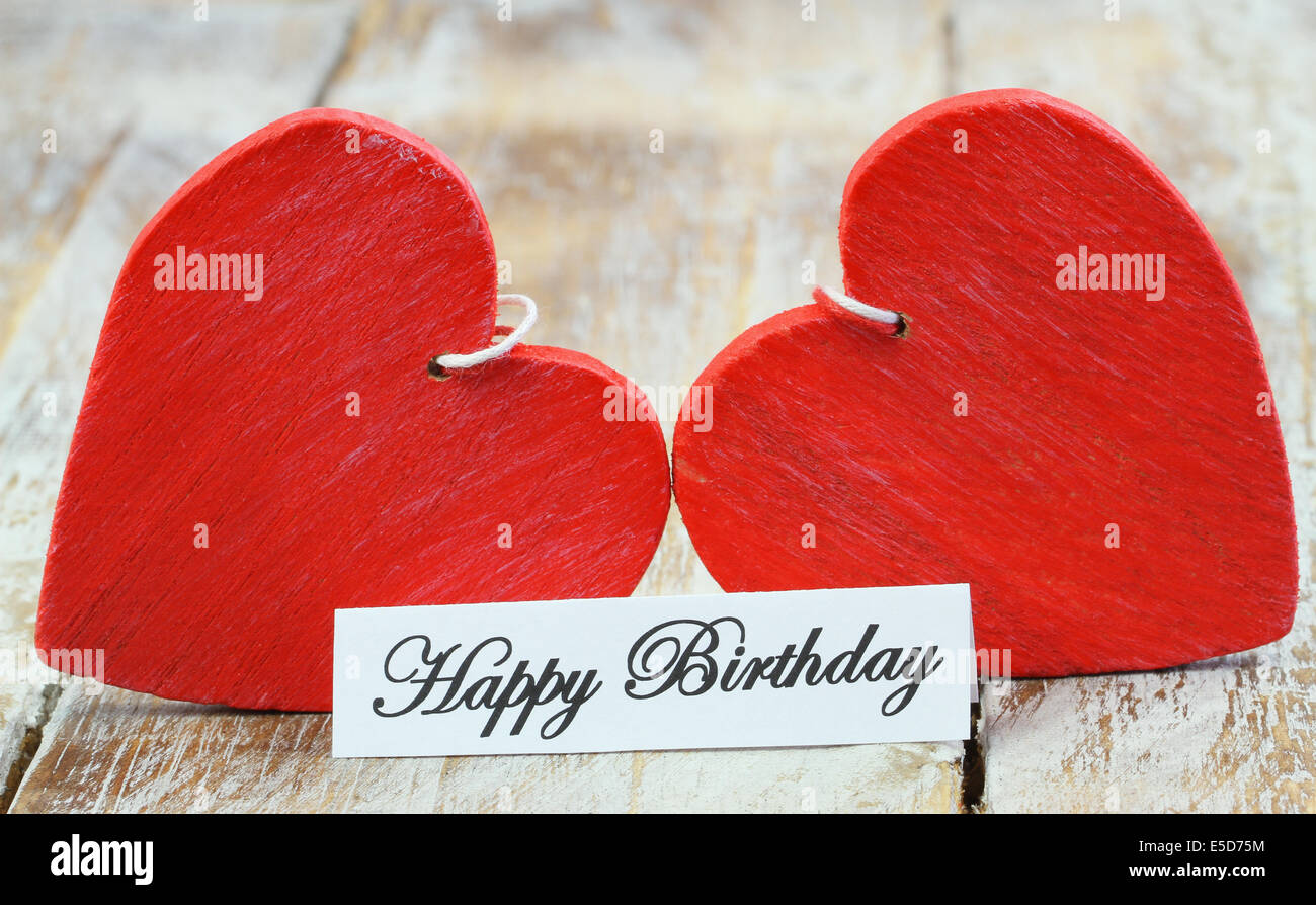 Happy birthday card with two red wooden hearts Stock Photo
