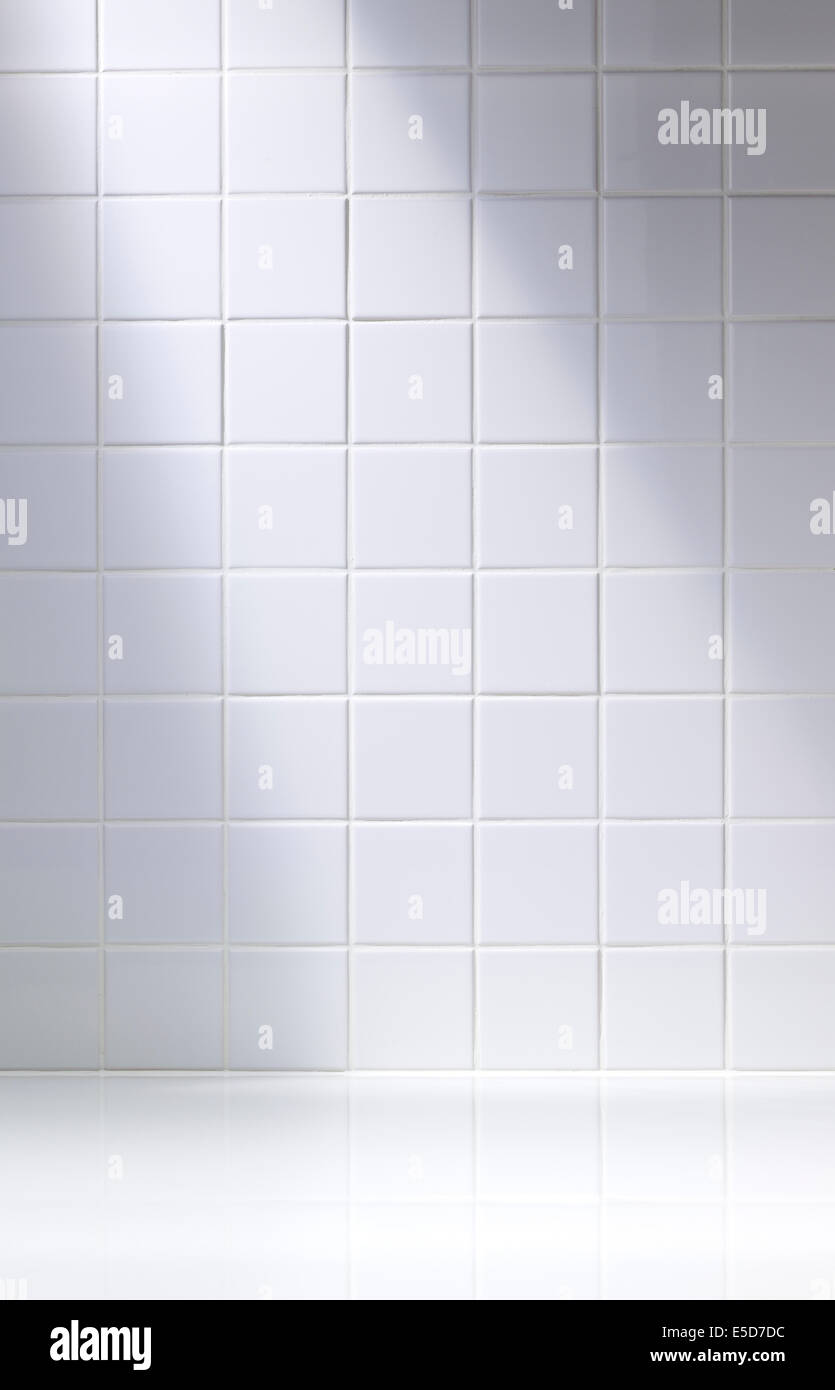 A vertical shot of a white tiled background or bathroom Stock Photo