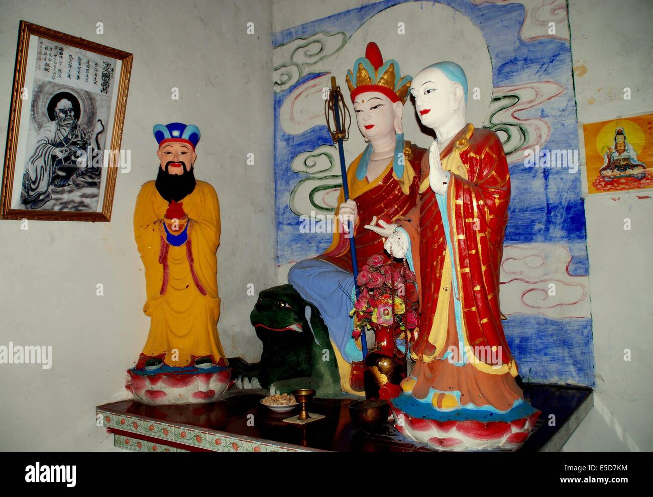 JIU CHI TOWN (SICHUAN), CHINA:  Buddha figures inside the small countryside Da Xiong Bao Dian temple Stock Photo