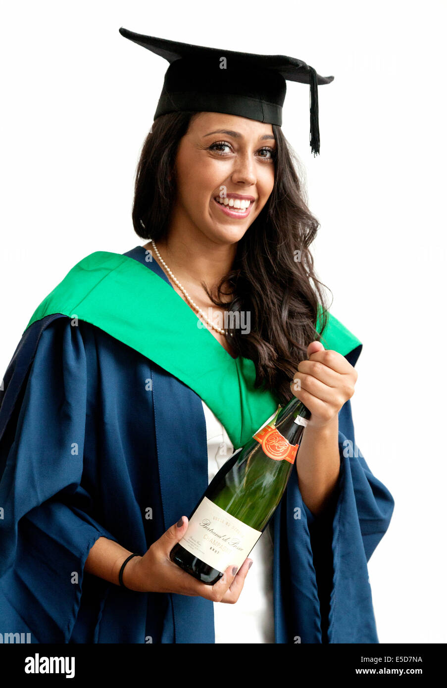 A woman graduate on her graduation day smiling and holding a bottle of champagne, UEA ( University of East Anglia ), Norwich UK Stock Photo