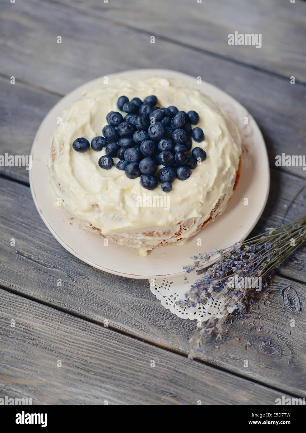 pie on a wooden table decorated with berries and lavender bouquet Stock Photo