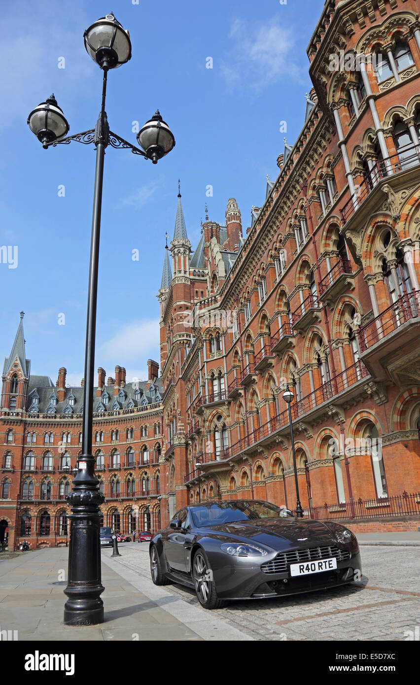 An Aston Martin DB9 sports car parked outside the St Pancras Hotel and St Pancras Apartments in London Stock Photo