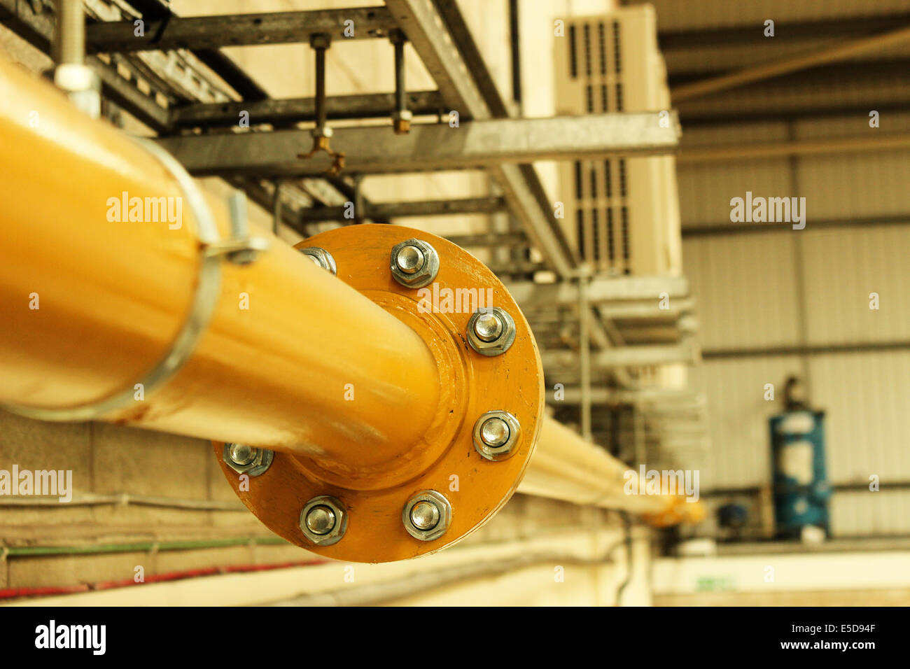Yellow industrial pipe work at the connection of two pipes Stock Photo Alamy