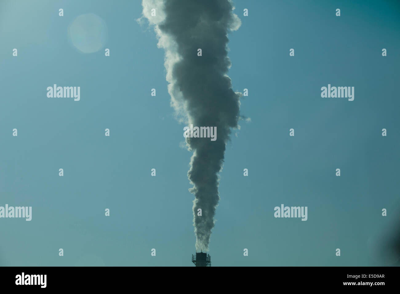 industrial chimney smoke sun flare pollution Stock Photo