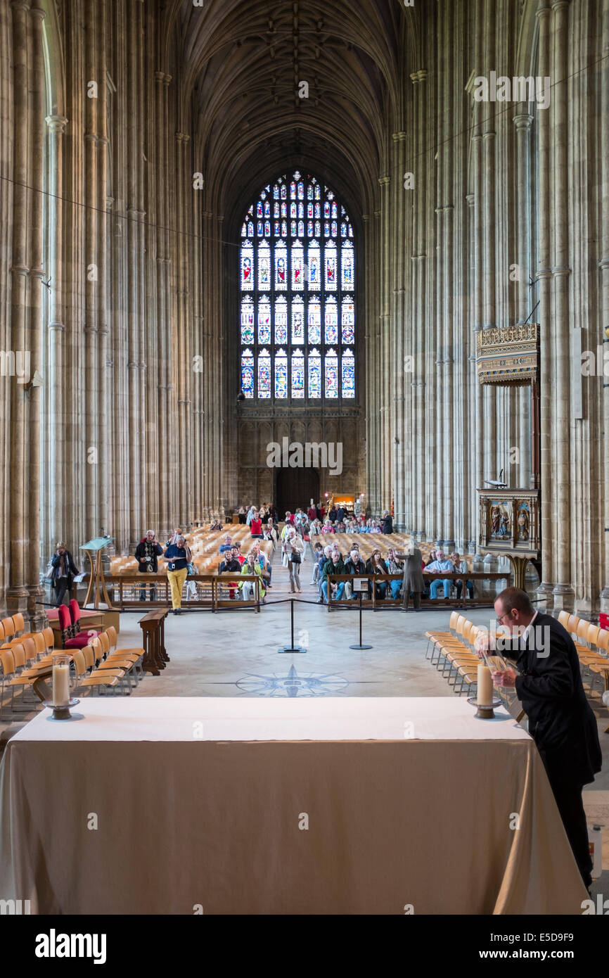 Assistant lighting the Candles on the altar of the Canterbury Cathedral, England, UK Stock Photo