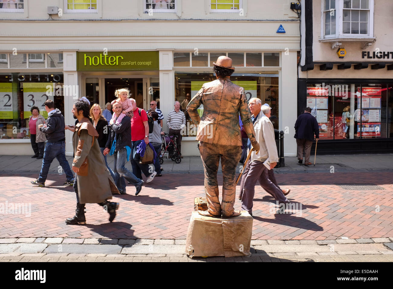Human statue performing Charlie Chaplin on the streets of Canterbury City Centre, UK Stock Photo