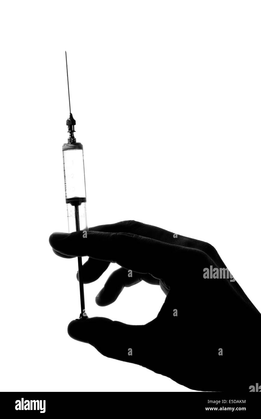 Silhouette old glass syringe in hand isolated on white Stock Photo