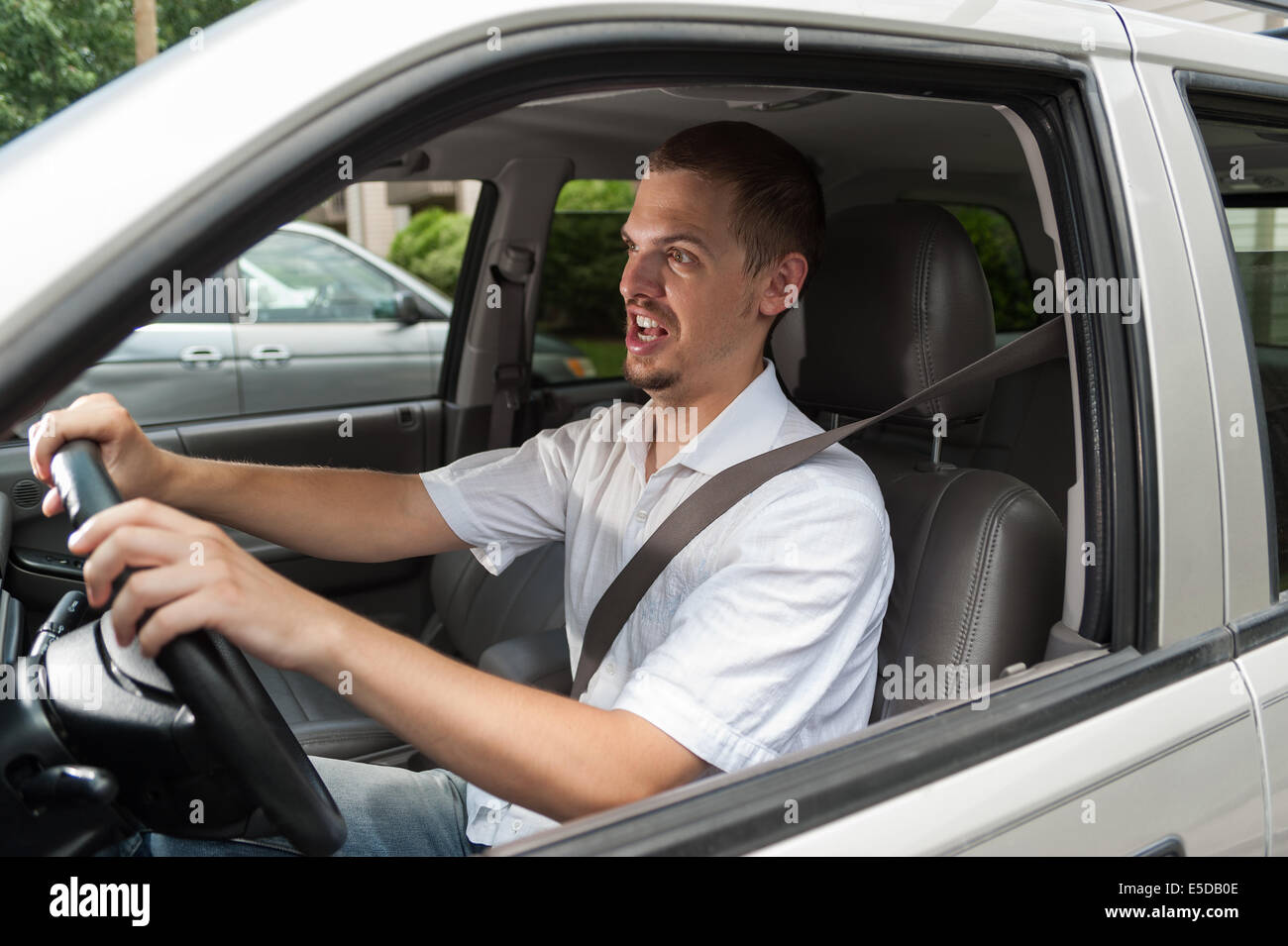 Young caucasian driver is shocked and opened his mouth Stock Photo