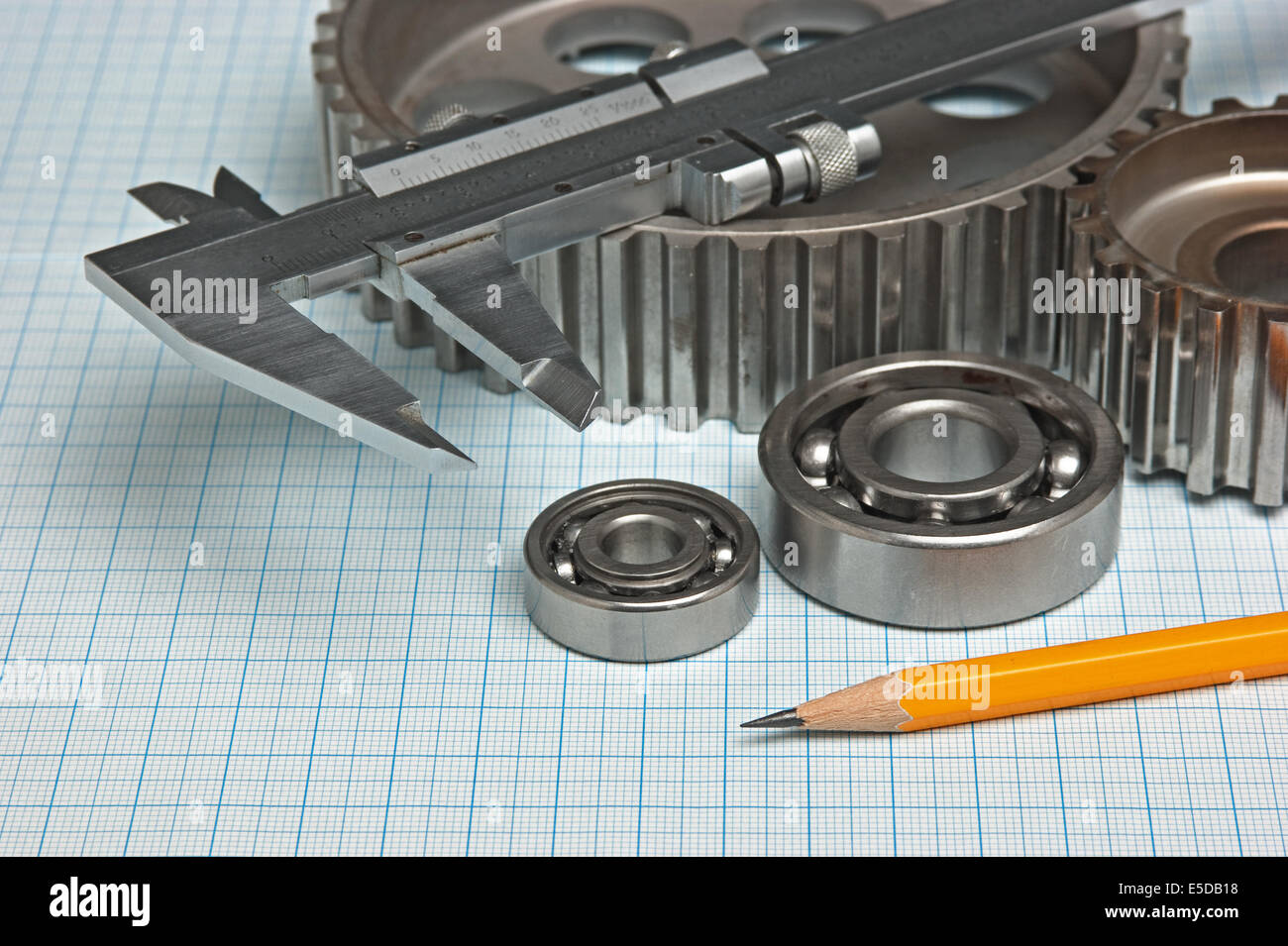 caliper with gears and bearings on graph paper Stock Photo