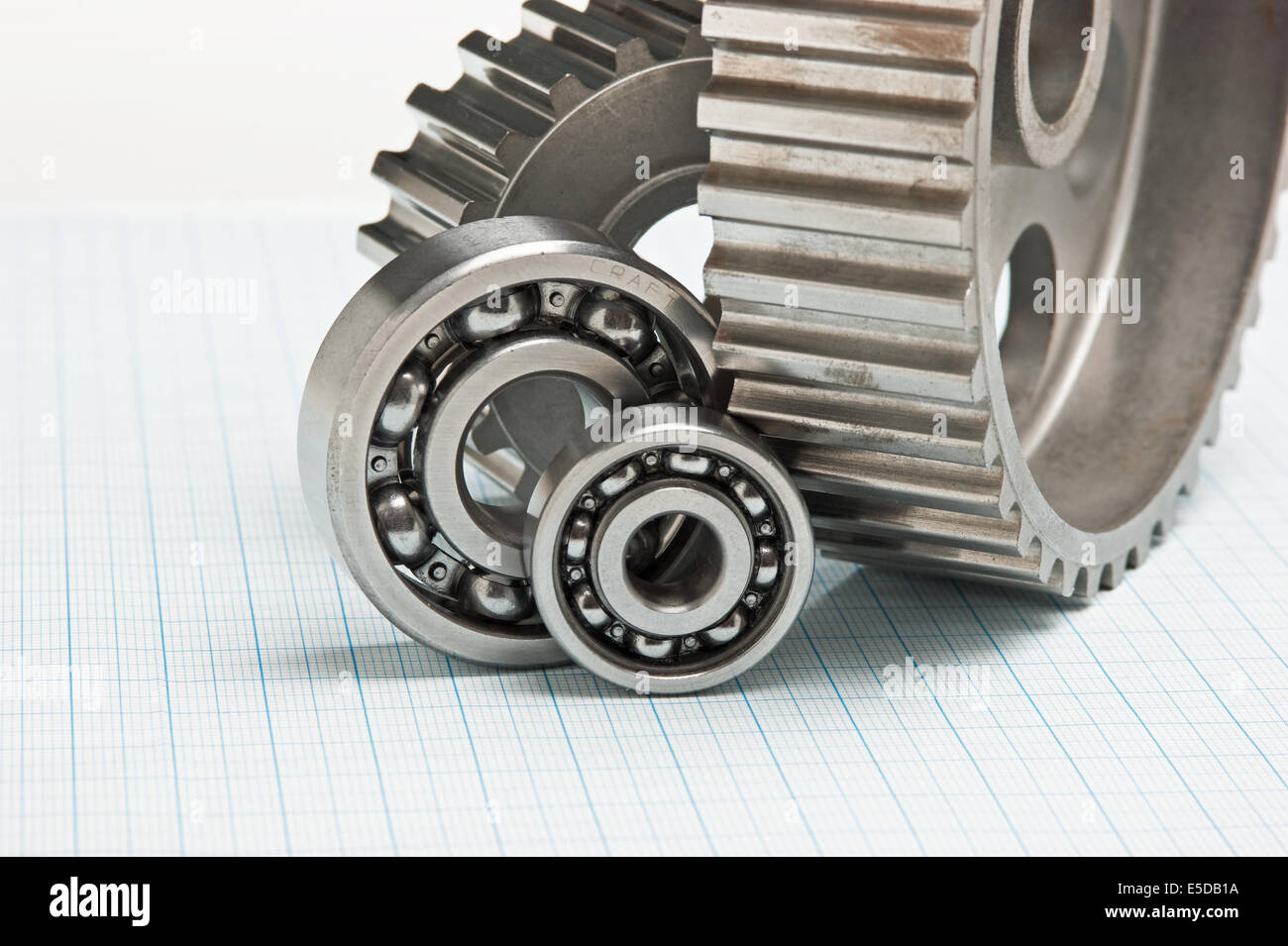 gears and bearings on graph paper Stock Photo Alamy