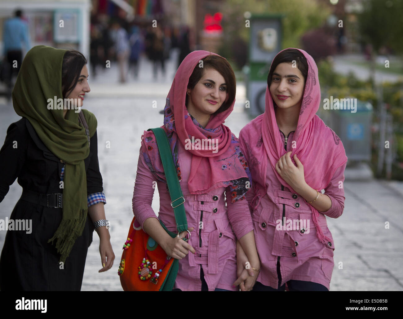 Isfahan, Iran. 28th July, 2014. Iranian young women walk on a corner of