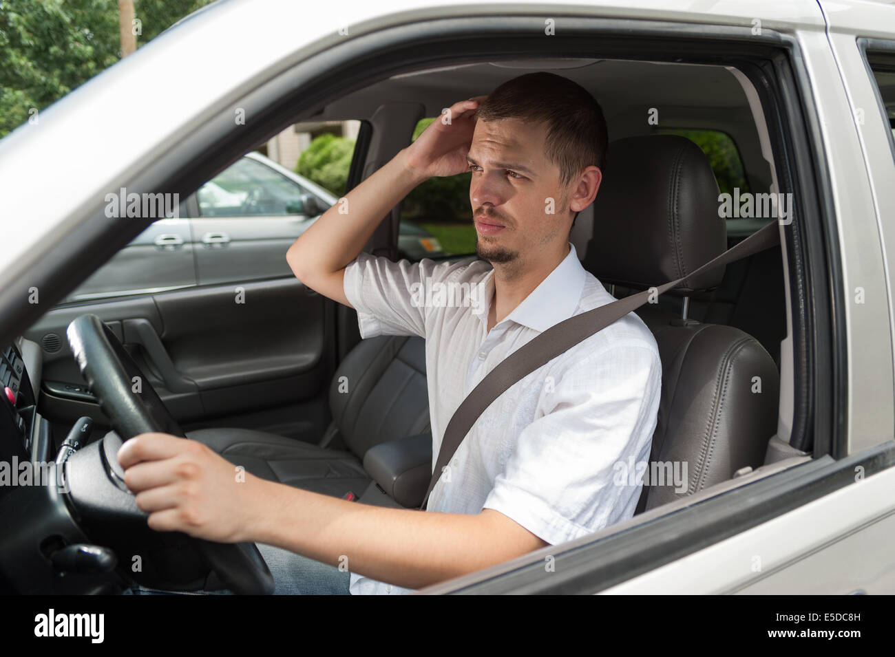 Young european driver is thinking about what to do or where to go Stock Photo