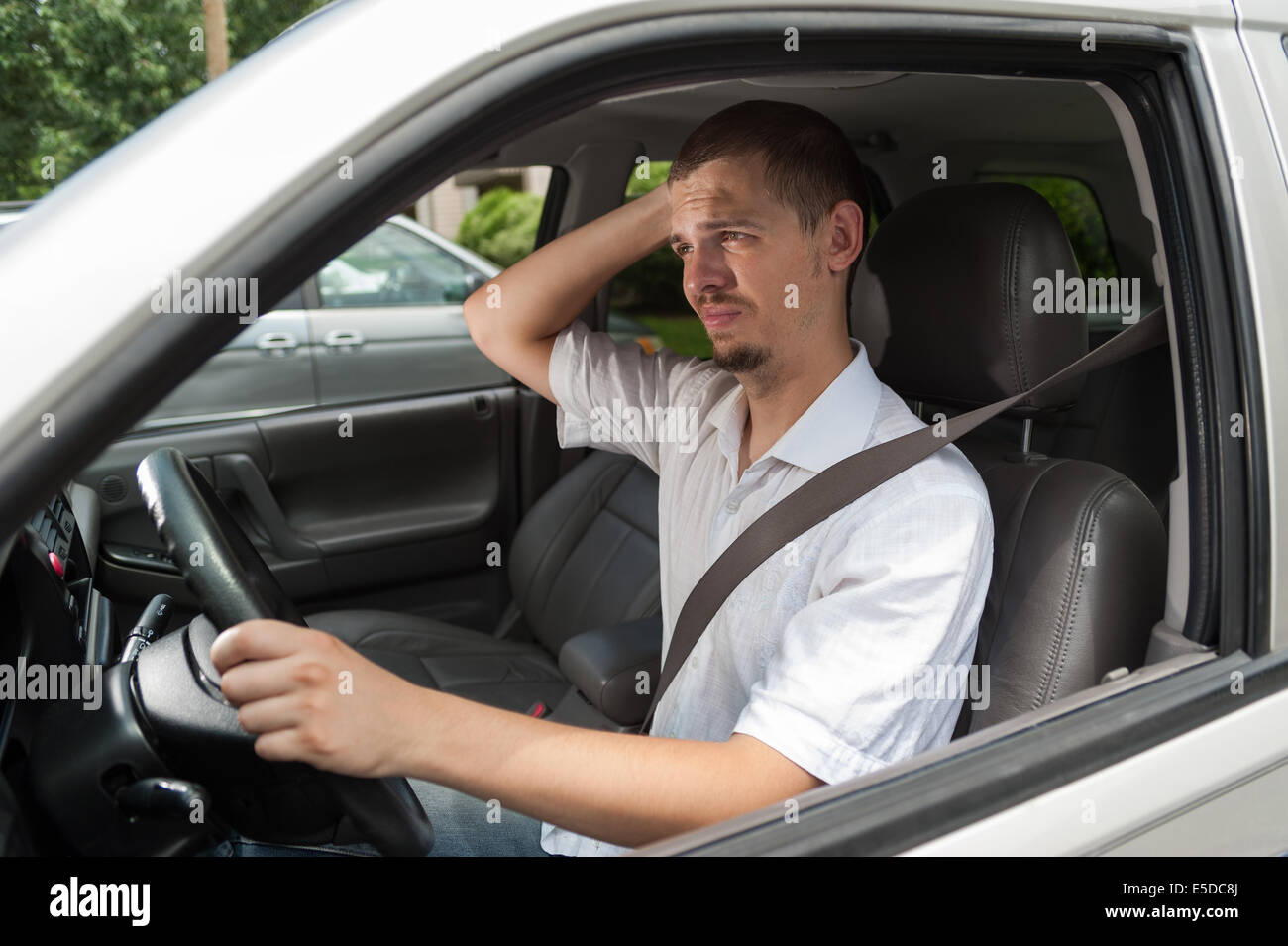 Young european driver is thinking about something Stock Photo