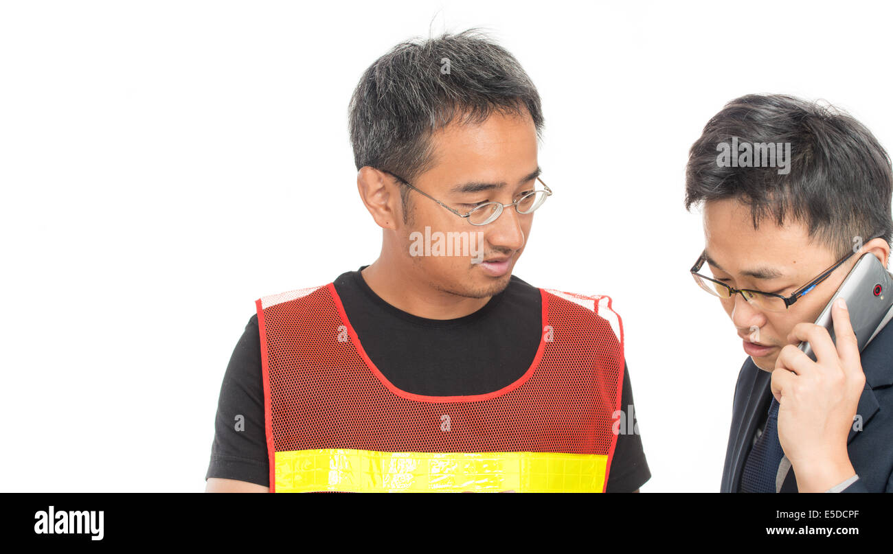 Worker with safety vest with his boss speaking at the phone. Isolated on white. Stock Photo