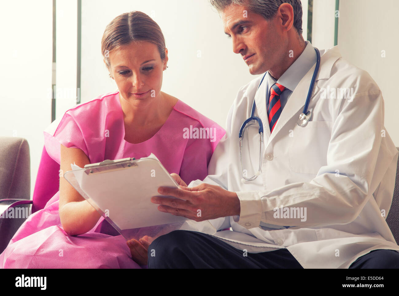 Male doctor showing medical exams to his patient woman Stock Photo Alamy