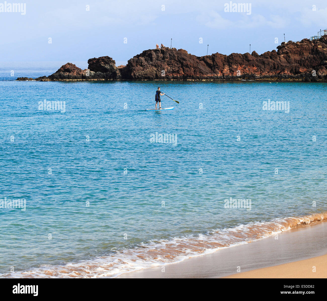 SUP approaches Black Rock at Kaanapali Beach on Maui Stock Photo