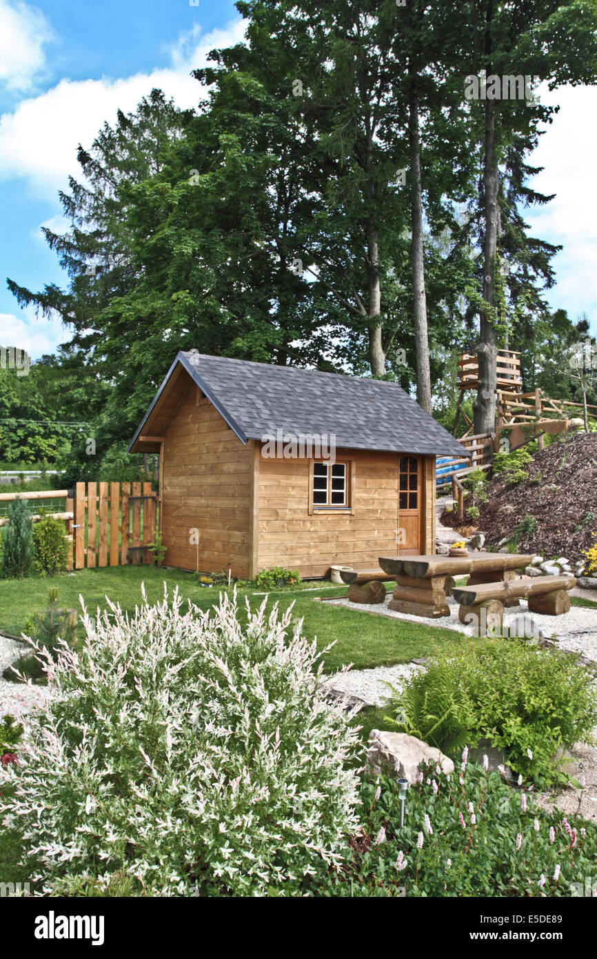 Wooden country house with garden Stock Photo - Alamy