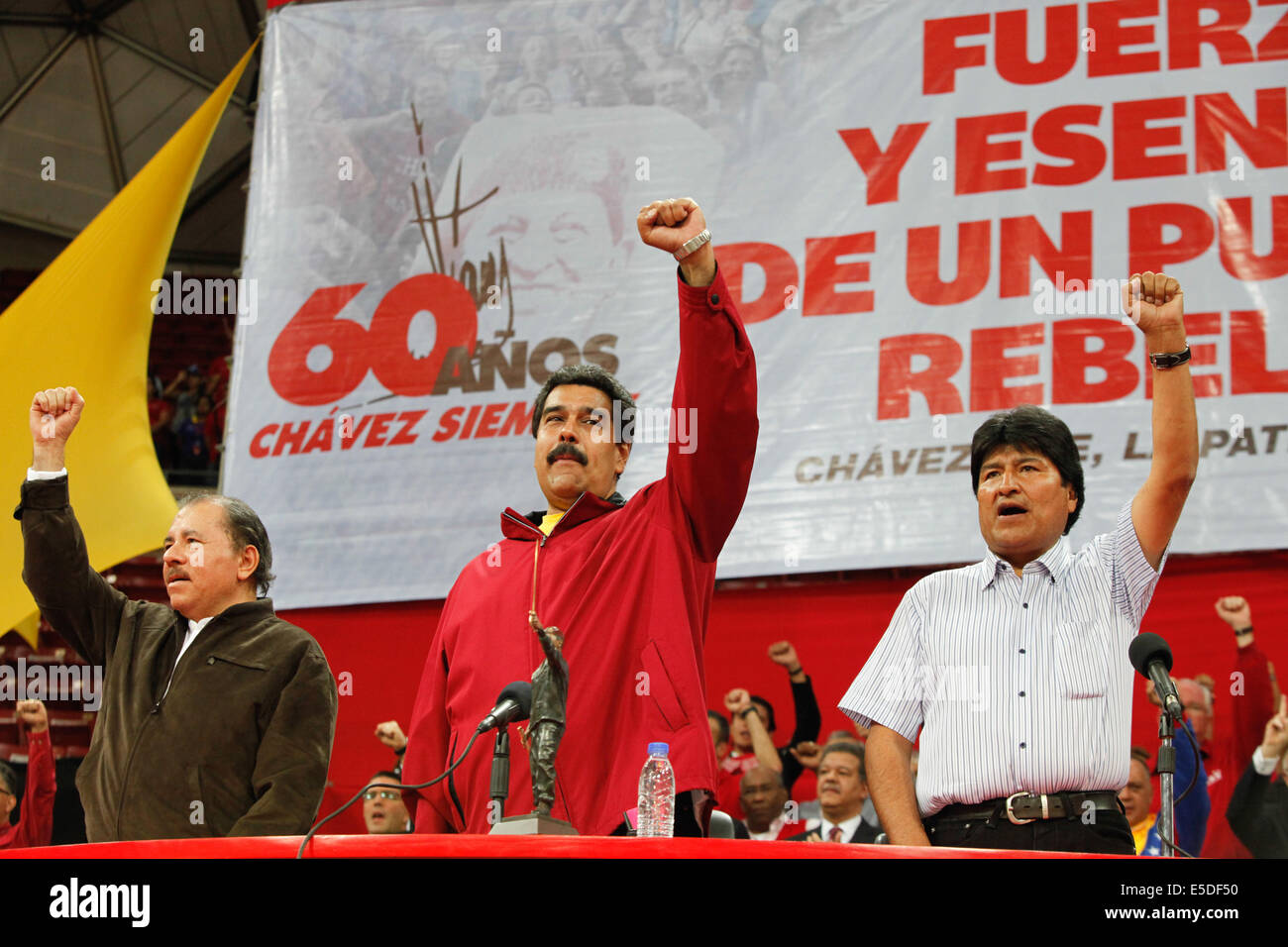 Caracas, Venezuela. 28th July, 2014. Venezuelan President Nicolas Maduro (C), Nicaraguan President Daniel Ortega (L) and Bolivian President Evo Morales (R) participate in the solidarity act with the Bolivarian Revolution and commemoration of the 60th birthday of the late president Hugo Chavez in the Poliedro de Caracas, in Caracas, Venezuela, on July 28, 2014. Credit:  Prensa Presidencial/AVN/Xinhua/Alamy Live News Stock Photo