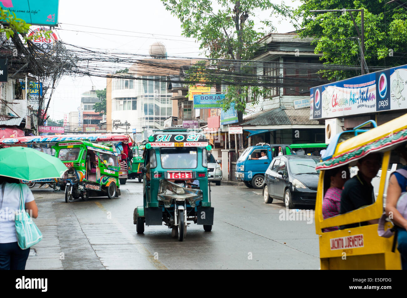 Street scene with tricycles, CBD, Cagayan de Oro, Misamis Oriental, Mindanao, Philippines Stock Photo
