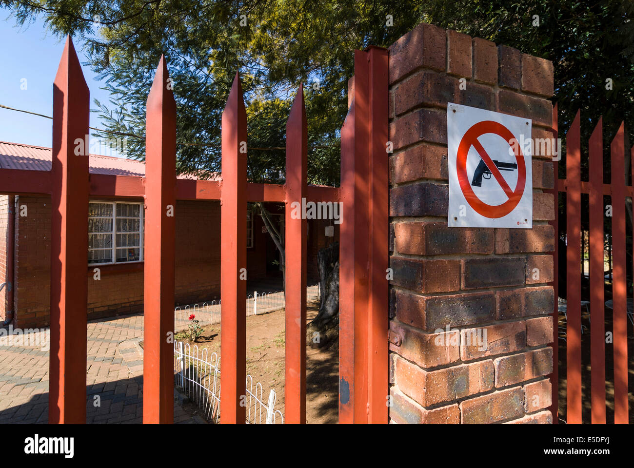 Sign, weapons forbidden, on wall in front of house, Soweto, Johannesburg, Gauteng, South Africa