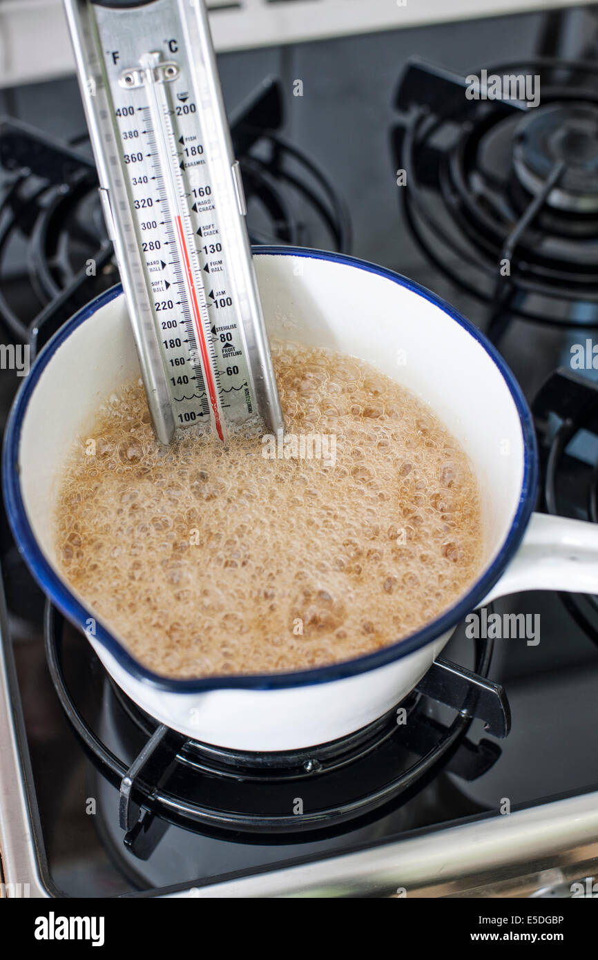cooking sweet sponge cake at home - measuring temperature of food in glass  bowl on water bath by infrared thermometer on stove at home kitchen Stock  Photo - Alamy