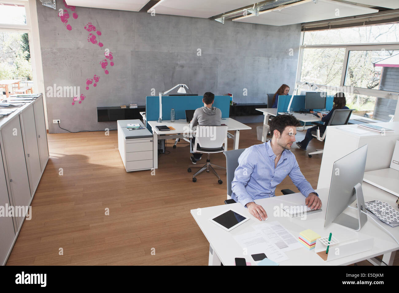 Four colleagues working in modern open space office Stock Photo - Alamy