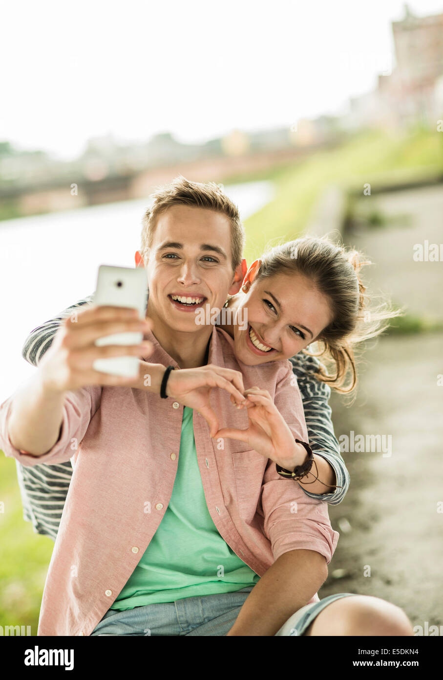 Happy young couple taking a selfie with smartphone Stock Photo - Alamy